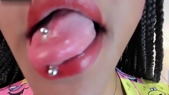 Close-Up Of Latina'S Blacked Out Tongue With Piercing