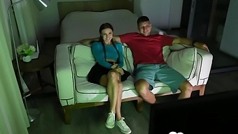 A Young Brunette Woman Gives Oral Pleasure To A Man On A Couch